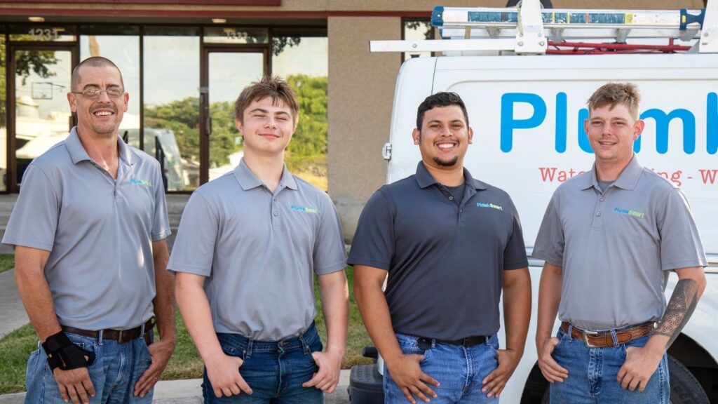4 PlumbSmart Plumbers in front of the company truck